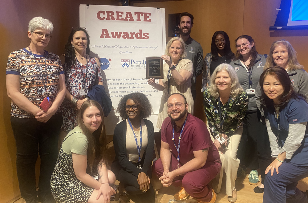 Members of the CTU pose with the Innovations in Clinical Research Operations Award they won.